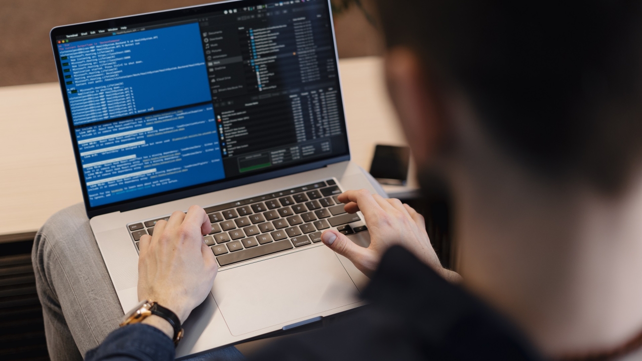 Man working on computer. Young it worker using laptop in the office, Internet marketing, technology, finance, business concept