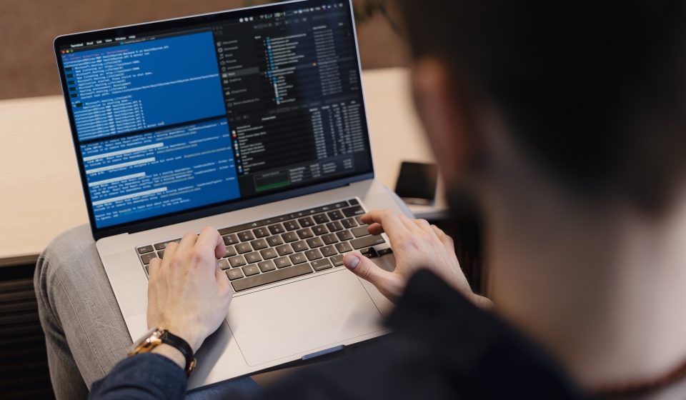 Man working on computer. Young it worker using laptop in the office, Internet marketing, technology, finance, business concept
