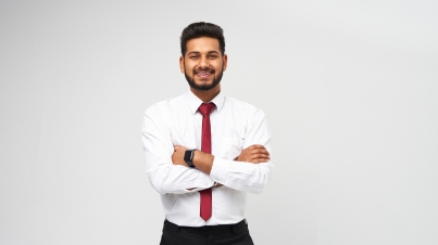 Portrait of young indian top manager in t-shirt and tie crossed arms and smiling on white isolated background