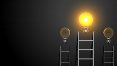 success concept ladder with glowing light bulb