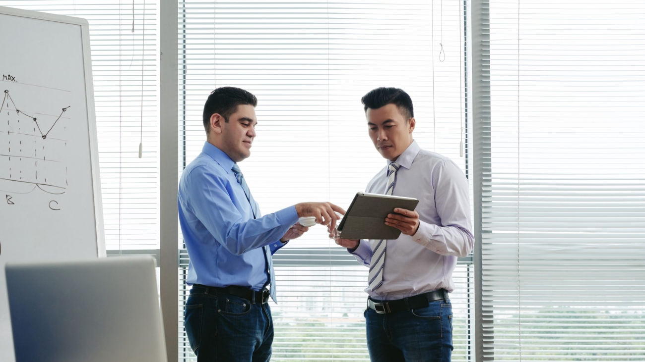 Businessmen discussing something on screen of digital tablet